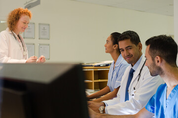 Fototapeta premium Hospital staff talking at front desk