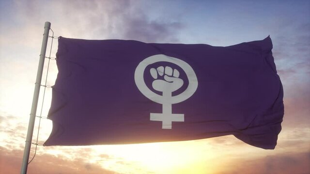 Feminist pride flag waving in the wind, sky and sun background