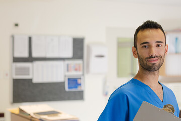 Doctor smiling in hospital hallway