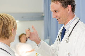 Obraz premium Doctor checking syringe in hospital room