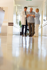 Fototapeta premium Doctor and nurse talking to patient in hospital room