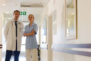 Doctor and nurse standing in hallway