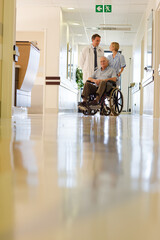 Doctor and nurse with older patient in hospital