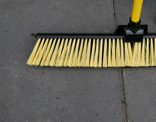 Yard broom with yellow bristles and handle with copy space