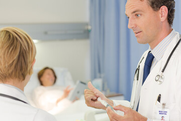 Fototapeta premium Doctor checking syringe in hospital room