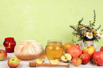 Autumn composition with apples, honey, pomegranate and candle. Harvesting concept, Jewish New Year Rosh Hashanah background, ecological food. Healthy eating, body detoxification,
