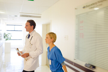 Fototapeta premium Nurse and doctor walking in hospital hallway