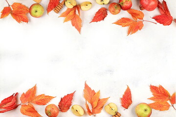 Happy Thanksgiving concept, greeting card. Autumn background with seasonal maple leaves and apples on light background, banner for screen, invitation, selective focus,