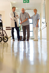 Fototapeta premium Doctor and nurse talking to patient in hospital room