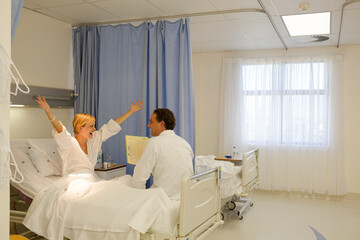 Doctor talking with patient in hospital room