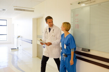 Nurse and doctor walking in hospital hallway