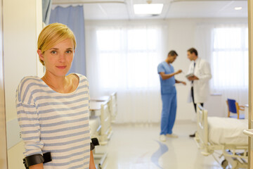 Patient using crutches in hospital room