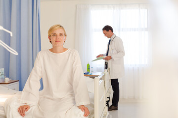 Patient wearing gown on hospital bed