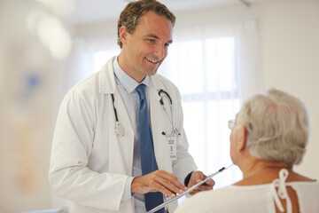 Doctor talking to older patient in hospital