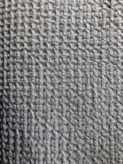 grey gridded textile background. close up