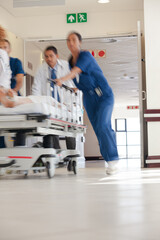 Hospital staff rushing patient to hospital room