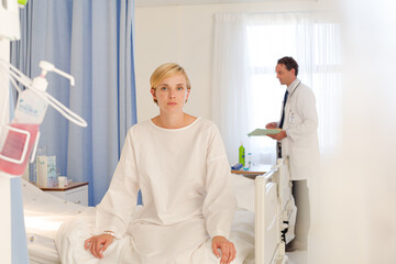 Fototapeta premium Patient wearing gown on hospital bed