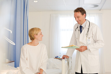 Obraz premium Doctor talking with patient in hospital room