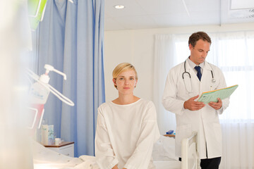 Doctor talking with patient in hospital room