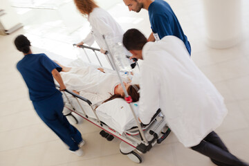 Hospital staff rushing patient to hospital room