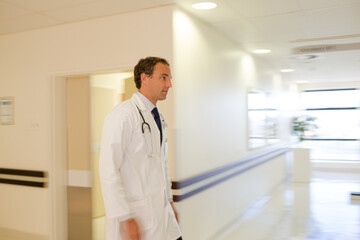 Naklejka na ściany i meble Doctor rushing in hospital hallway
