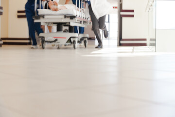 Hospital staff rushing patient to hospital room