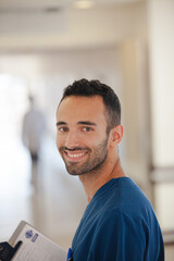 Nurse smiling in hospital hallway