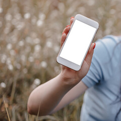 Woman hand showing a blank smartphone screen to camera.
Hand holding new phone. 
Mockup image blank screen cell phone. White empty space for advertise, mobile ads , web services. People communication.