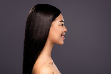 Profile photo of gorgeous cheerful korean lady look empty space toothy smile isolated grey color background