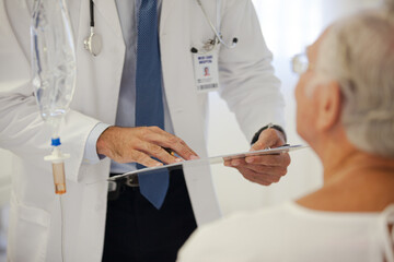 Doctor talking to older patient in hospital