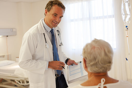 Doctor talking with patient in hospital room