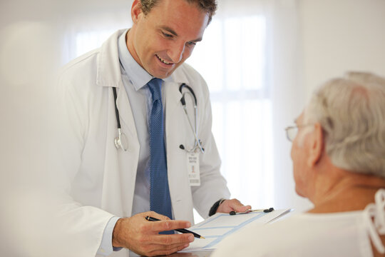 Doctor talking to older patient in hospital
