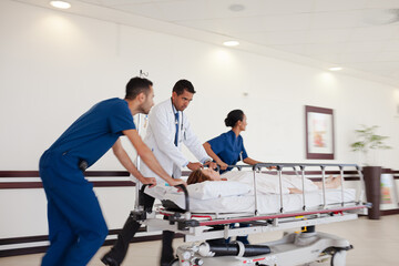 Hospital staff rushing patient to hospital room