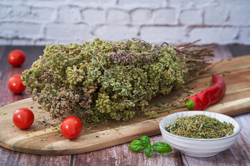 Dried oregano bouquet with tomatoes and chilli. 