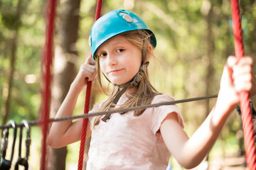 happy smiling girl riding a zip line
