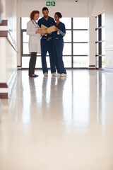 Hospital staff talking in hallway