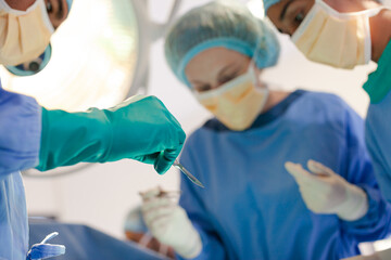 Surgeons bent over patient on operating table