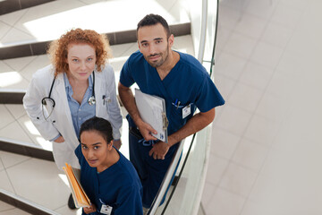 Doctor and nurses on hospital steps