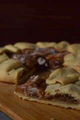 galette or an open pie with apples and cinnamon on a wooden board