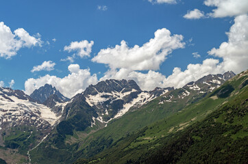 Naklejka premium Beautiful mountain landscape with snowy peaks and clouds. highlands in summer.