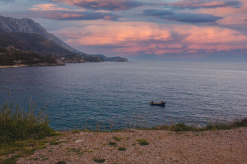 Sunset at sea and lonely boat