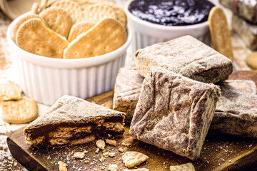 Italian straw, Brazilian chocolate candy, crushed cornstarch biscuits and condensed milk.