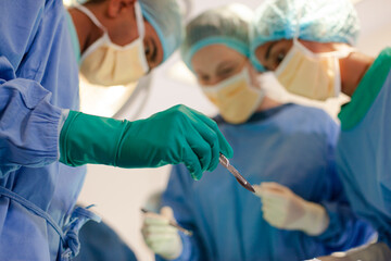 Surgeons bent over patient on operating table