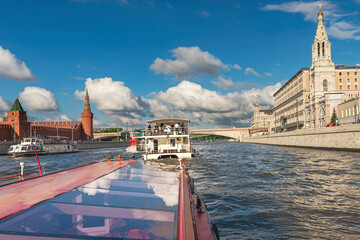 river tourist ships sail along the Moskva River near the walls of the Moscow Kremlin