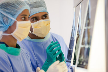 Surgeons examining x-rays in hospital