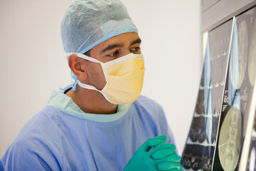 Fototapeta na wymiar Surgeon examining x-rays in operating room
