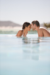 Fototapeta premium Couple relaxing together in swimming pool
