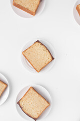 Top view of loaf slices with a chocolate coating, flatlay of vanilla cake slices