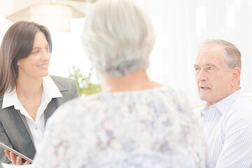 Financial advisor using tablet computer with clients