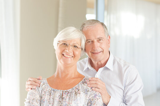 Older couple smiling together indoors